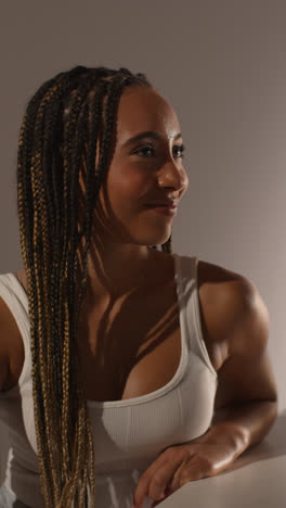 Studio-Beauty-Shot-Of-Young-Woman-With-Long-Braided-Hair-Against-Neutral-Background-In-Profile-1